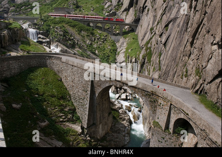 Switzerland. Travel by Train in Switzerland. The Matterhorn-Gotthard bahn train crosses above the Devil's Bridge, the Teufelsbr Stock Photo