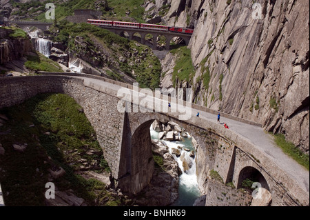 Switzerland. Travel by Train in Switzerland. The Matterhorn-Gotthard bahn train crosses above the Devil's Bridge, the Teufelsbr Stock Photo