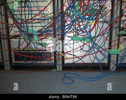 messy colorful wires in front of server Stock Photo
