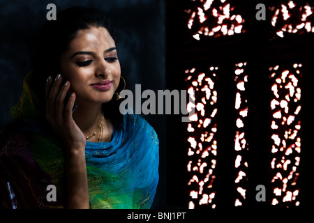 Muslim woman talking on the phone Stock Photo