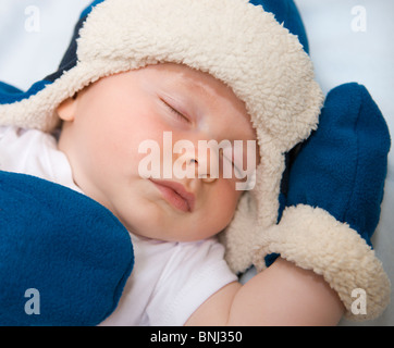 Beautiful 4 month old baby in hat sleeping. Stock Photo