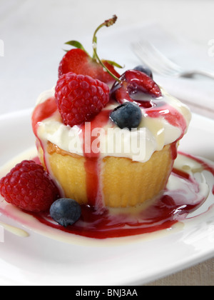 Spanish traditional sponge cake with evaporated and condensed milk topped with whipped cream and fruit Stock Photo