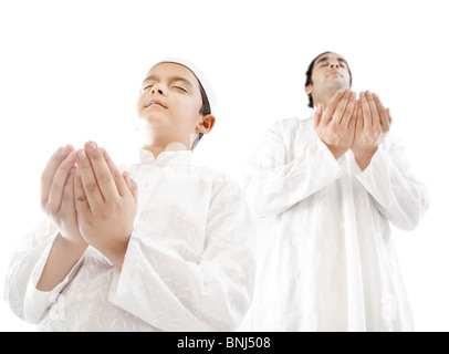 Muslim man and his son praying Stock Photo