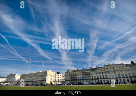 Jet streaks and Jet streams from planes fill the skies above Brunswick Terrace and Brunswick Square at Hove lawns in Sussex Stock Photo