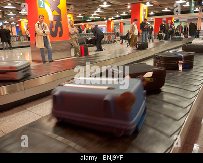 Cases / suitcases / trunks arrive on the conveyor belt at the baggage collection of the Dusseldorf airport. Stock Photo