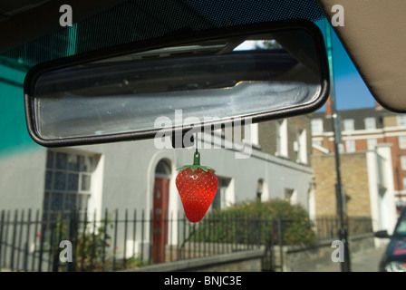 Car air freshener hanging from internal rear view drivers car mirror. London UK HOMER SYKES Stock Photo