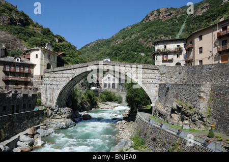 Roman bridge over torrente Lys Pont St Martin Aosta Valley Italy Hydro electric generator can be seen under bridge Stock Photo