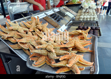 Starfish for sale in Donganmen Street night food market, Beijing, China Stock Photo