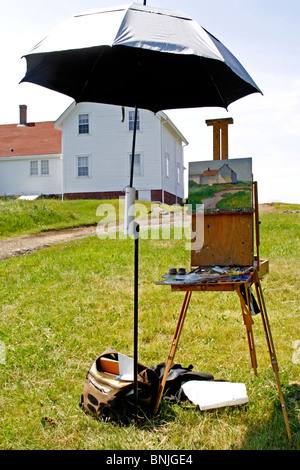Maine coast Monhegan Island artist colony New England USA remote offshore art class painting woman at lighthouse Stock Photo