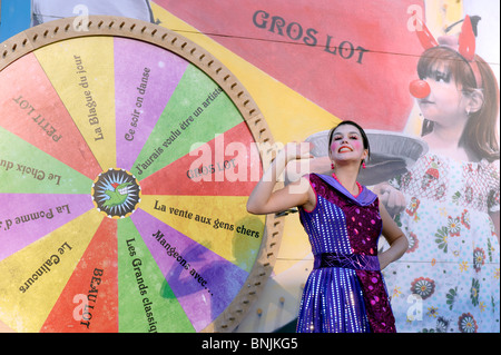 Colorful  hostess inviting people to spin the wheel of fortune at the Montreal Just for Laughs Festival. Stock Photo