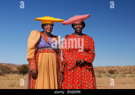 Herero Women Khorixas Damaraland Kunene Region Namibia Africa Travel traditional costume hat Stock Photo