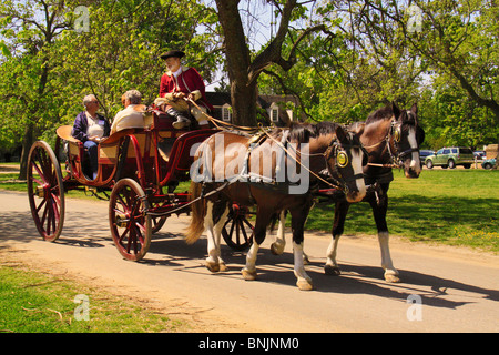 Tourist take carriage ride through the Historic Area in Colonial Williamsburg, Virginia, USA Stock Photo