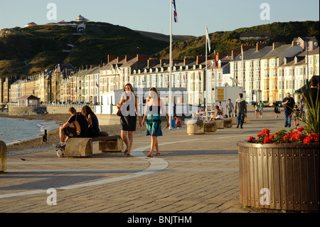 People strolling on the promenade on a summer evening, Aberystwyth Wales UK Stock Photo