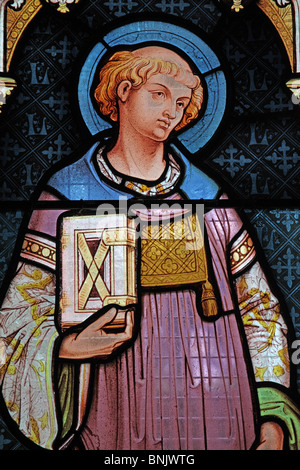 A stained glass window by Frank Holt depicting Saint Laurence, Church of St Laurence, Lighthorne, Warwickshire, England Stock Photo