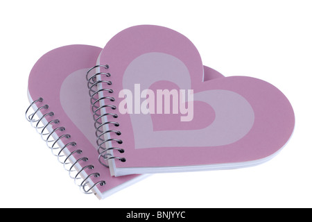 Two heart shaped metal ringbound pink notebooks Stock Photo