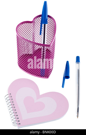 Heart shaped metal mesh pink pencil holder pen top and notebook Stock Photo