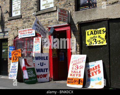 Advertising boards outside a shoe repair & key cutting shop in the U.K. Stock Photo