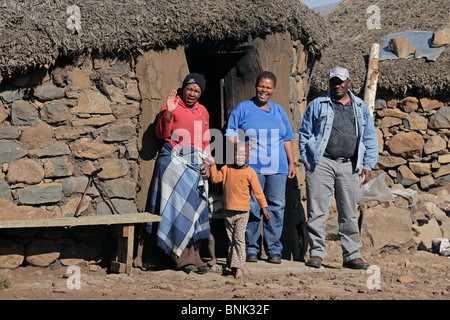 Basotho family in front of a traditional hut in the high Maluti mountains of the Kingdom of Lesotho, southern Africa Stock Photo