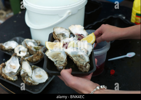 A plate of oysters with lemon wedges at the Whitstable Oyster Festival Stock Photo