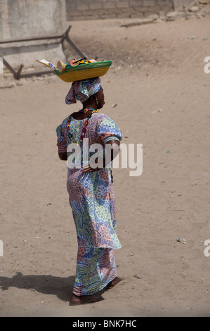 Africa, Senegal, Dakar. Fulani village, semi-nomadic tribe located along the shores of the Pink Lake of Retba. Female vendor in Stock Photo