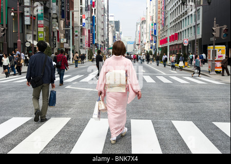 Woman wearing a kimono on Chuo-dori in Ginza 4-chome, Tokyo, Japan Stock Photo