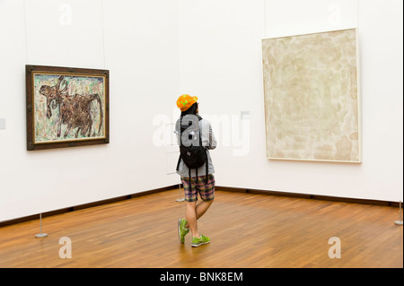 Young man looking at modern art in the National Museum of Western Art, Tokyo, Japan Stock Photo