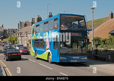 A local Purbeck Breezer public bus, Route 40, on its way to Swanage, blocking traffic in Corfe Castle, Dorset, UK. Stock Photo