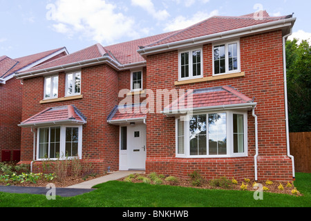 Photo of a brand new unoccupied detached red brick built five bedroom house on a modern housing development. Stock Photo