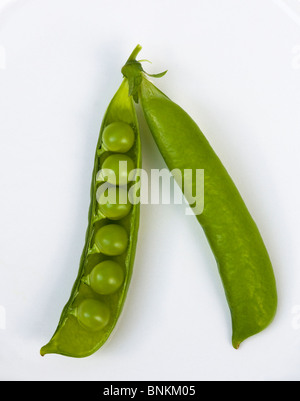 Home grown Open pea pod showing six fresh green peas Stock Photo