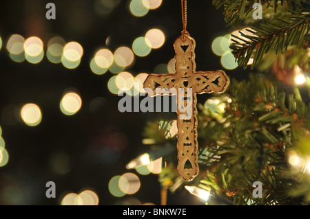 Cross ornament on Christmas tree with bokeh. Taken with a remote to reduce blur at ISO 200. Stock Photo