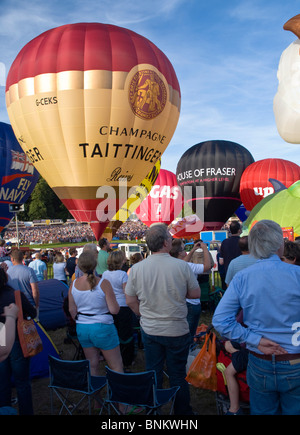 Hot air balloons being prepped for a mass ascent and crowds watching at the Bristol Balloon fiesta. Stock Photo