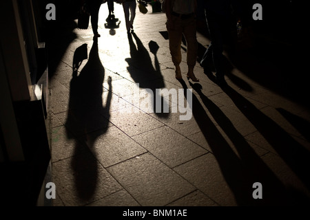 Shopper's shadows are cast in a commercial area of downtown Sevilla, Andalusia, Spain, May 31, 2010. Stock Photo