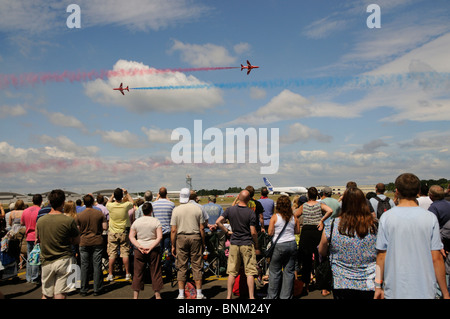 Red Arrows RAF formation flying team being watched by spectators at the Farnborough Air Show in southern England UK Stock Photo