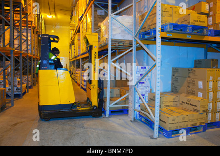 Fork Lift Truck operating in a frozen goods warehouse. Stock Photo