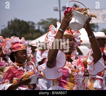 Local attractive women dancing in the street parade during the unique Seu Festival held each year in Curacao, Caribbean Stock Photo