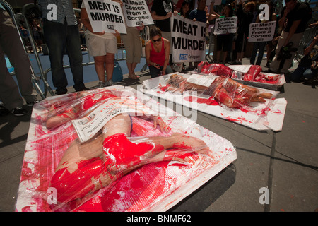 Activists from the animal rights group PETA protest the slaughter of animals in the production of meat in Times Square in NY Stock Photo