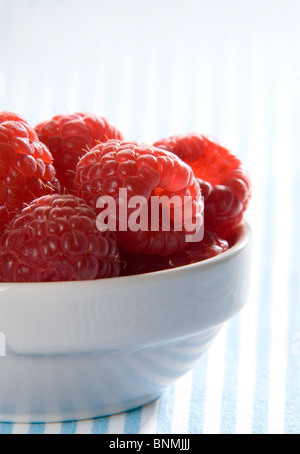 fresh red raspberries in a white bawl Stock Photo