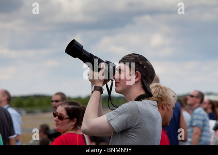 photographer with long lens at an air show. Stock Photo