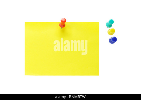 Multicolor push pins and yellow note paper on white background Stock Photo