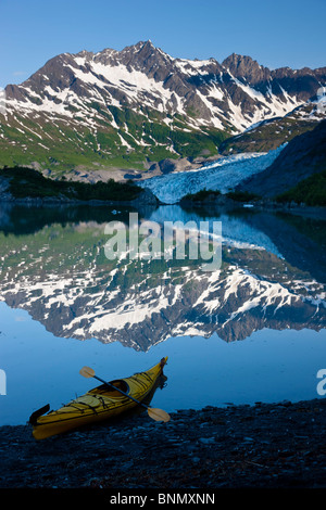 Kayak on the beach in Shoup Bay with Shoup Glacier reflected in the water, Prince William Sound,  Alaska Stock Photo