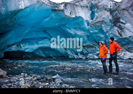 Male & female kayakers explore an ice cave in front of Shoup Glacier, Shoup Bay State marine Park, Prince William Sound, Alaska Stock Photo