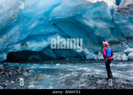 Female kayaker explores an ice cave in front of Shoup Glacier, Shoup Bay State marine Park, Prince William Sound, Alaska Stock Photo