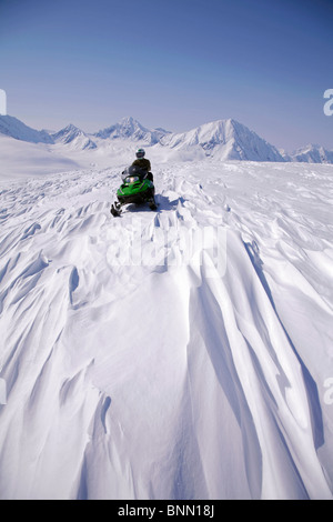 Snowmobiler on Spencer Glacier near the top of Blackstone Glacier, Kenai Mountains, Chugach National Forest, Alaska Stock Photo