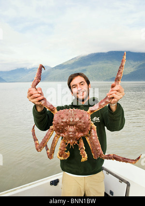 Man holding a king crab Stock Photo - Alamy