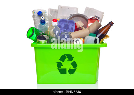 Photo of a green recycling bin full of recyclable items isolated on a white background. Stock Photo