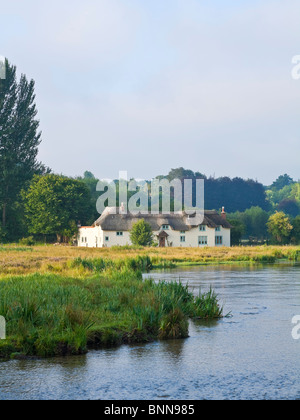 Picturesque thatched cottage and river Test Chilbolton Cow Common Hampshire UK Stock Photo