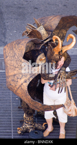 STREET ARTISTS HUMAN STATUES IN DRAGON FANCY DRESS ON LAS RAMBLAS BARCELONA SPAIN EUROPE Stock Photo