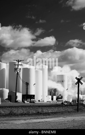 White chimney smoke polluting our nations air, black and white Stock Photo