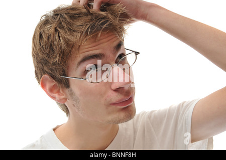 A young white male Caucasian adult scratching head isolated on white Stock Photo