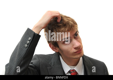 A young white male Caucasian adult in business suit scratching head like a monkey isolated on white Stock Photo